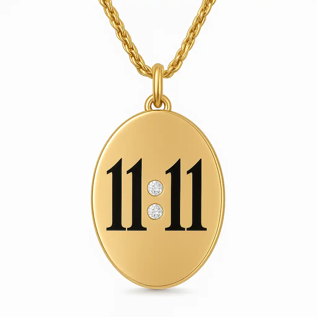 A photograph showcases an oval-shaped gold pendant necklace featuring the number 11:11 in black with two small diamonds forming the colon, symbolizing synchronicity and manifestation.