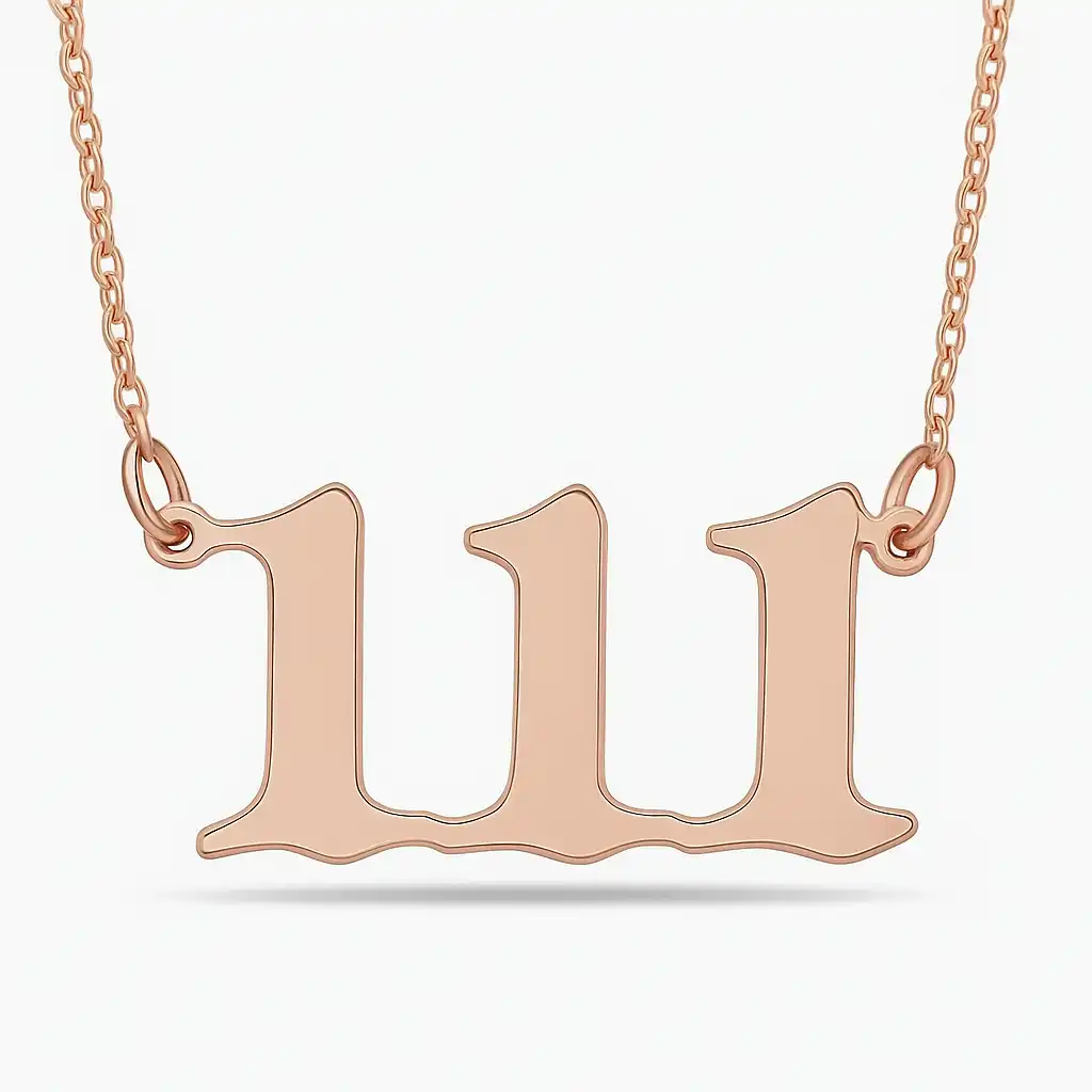 A close-up photograph of a rose gold necklace featuring the number "111" in a bold, stylized font, hanging from a delicate twisted chain.