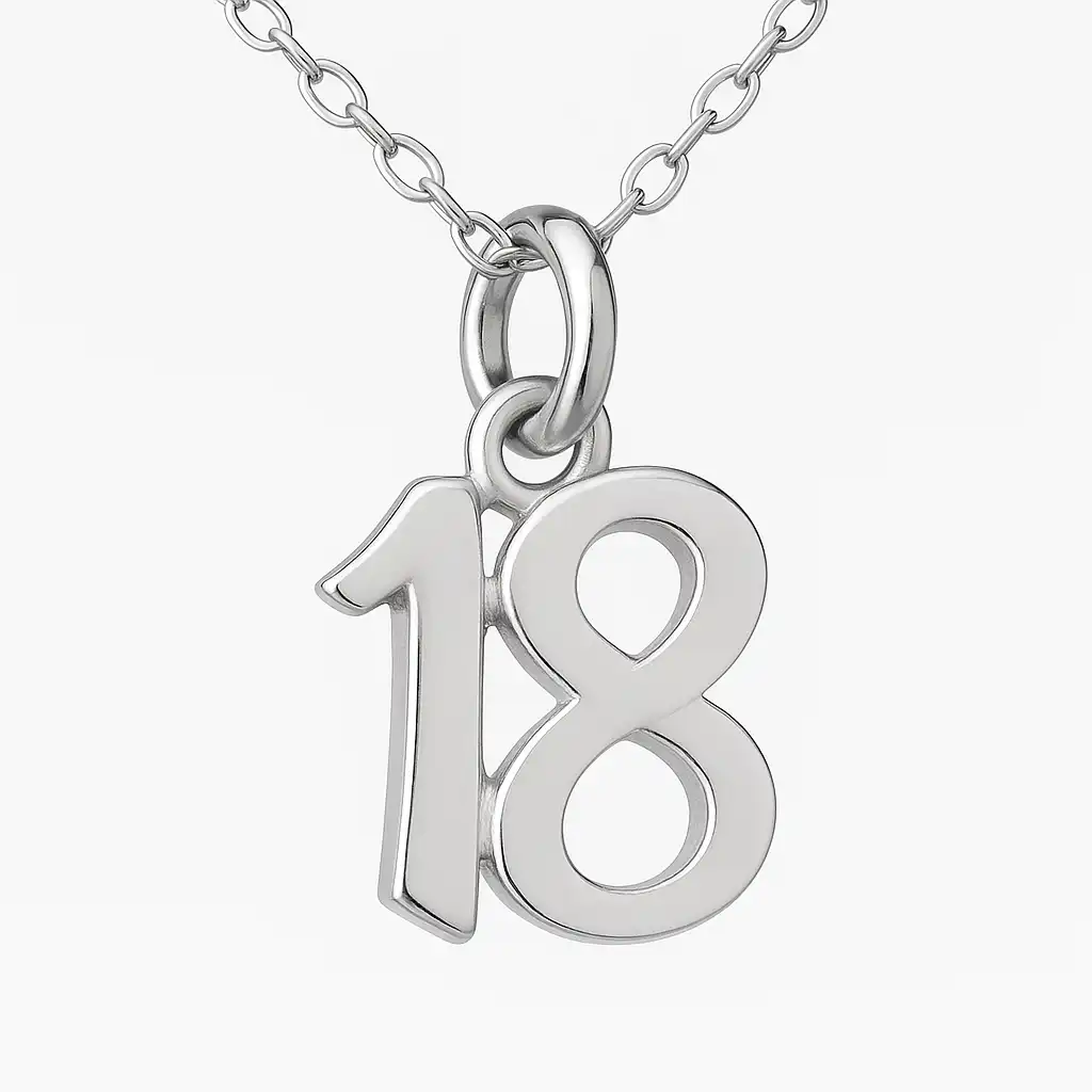A silver pendant shaped like the number 18, hanging from a delicate chain, photographed in a well-lit studio setting with a white background.
