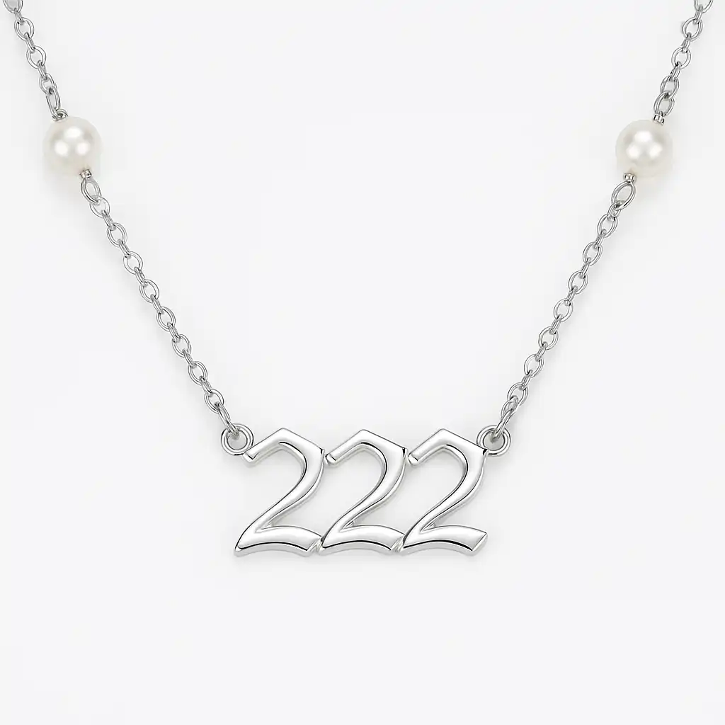 A silver necklace featuring the number 222 in an ornate font, accented with evenly spaced pearl-like beads along the chain, displayed on a white background.