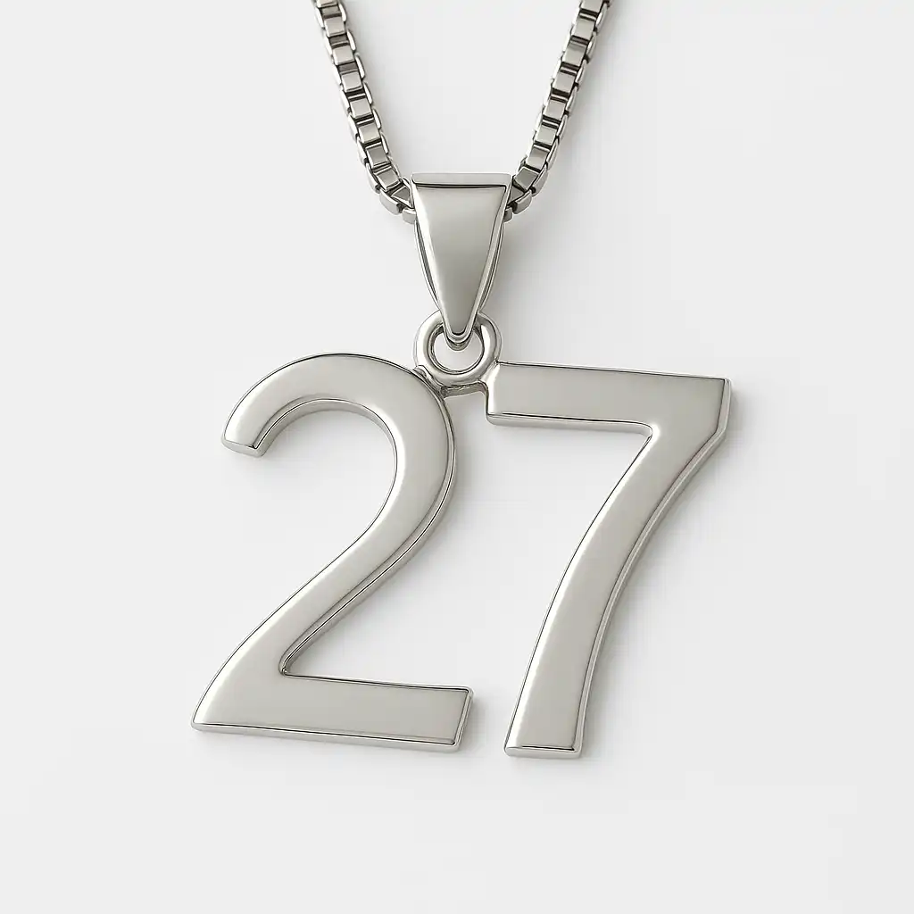A silver pendant shaped like the number 27, hanging from a box chain necklace, set against a soft white background.