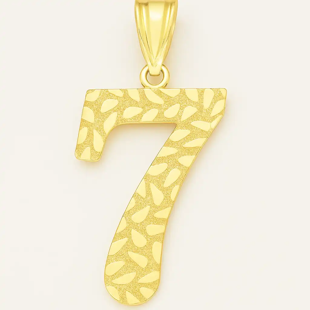 A photograph presents a gold pendant in the shape of the number 7, suspended from a matching gold chain, against a soft neutral background.
