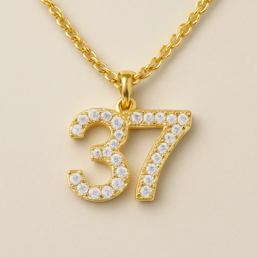 A digital photograph showcases a gold number "37" pendant resting on a smooth, neutral background, symbolizing numerological meaning and personal energy.