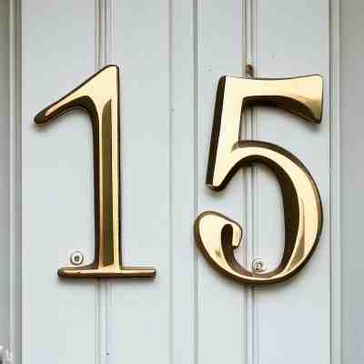 House numbers 15 in gold metal lettering.